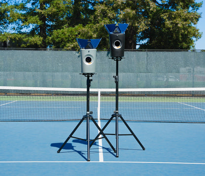 Two Hydrogen Sports ball machines mounted on elevated stands on a tennis court.